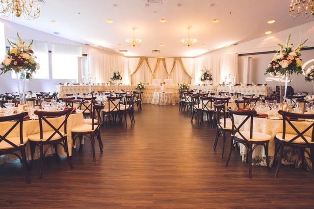 Elegant wedding setup with floral arrangements at Carmen's Event Centre.