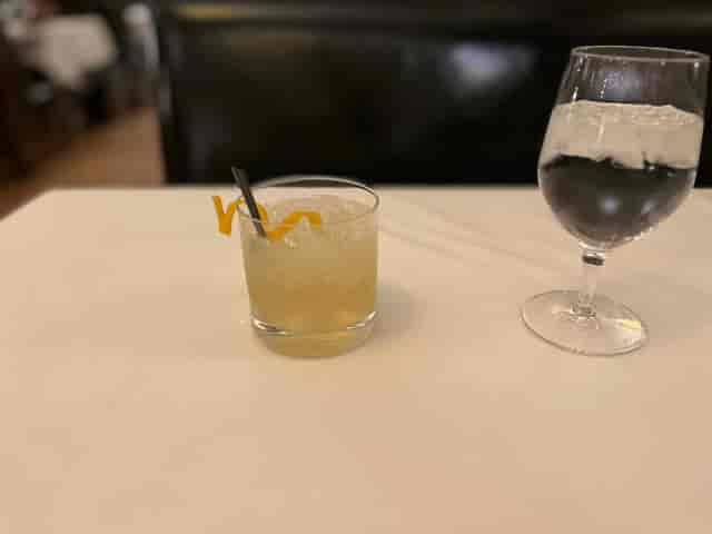 Semi-private meeting setup with cocktails and sparkling water at The Grill on the Alley.