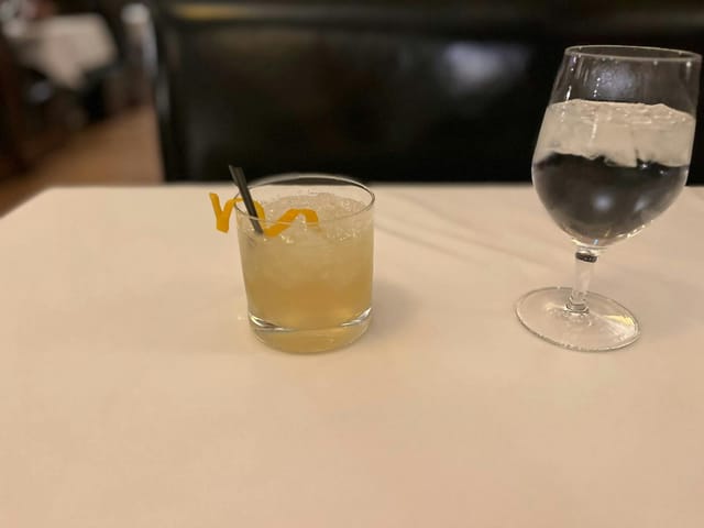 Semi-private meeting setup with cocktails and sparkling water at The Grill on the Alley.