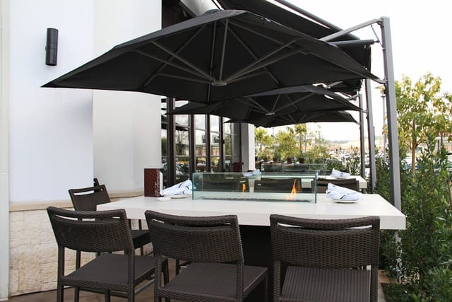 Semi-private outdoor dining at Il Fornaio with modern furniture for events