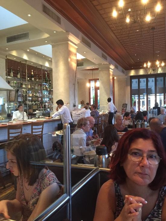 Bustling Il Fornaio restaurant, inviting atmosphere for casual networking events.