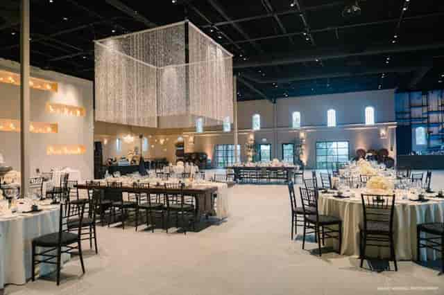 Elegant ballroom at Palm Event Center with round tables, ideal for weddings and corporate events.