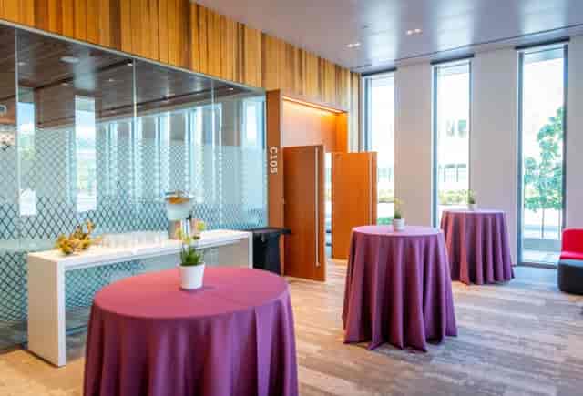 Modern conference room at Stanford with purple tables for networking events.