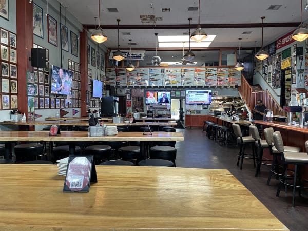 Spacious BarZola restaurant with sports decor, ideal for casual gatherings and events