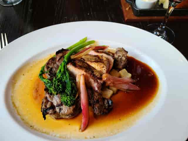 Grilled meat entrée with vegetables at Culinary Institute of America event catering