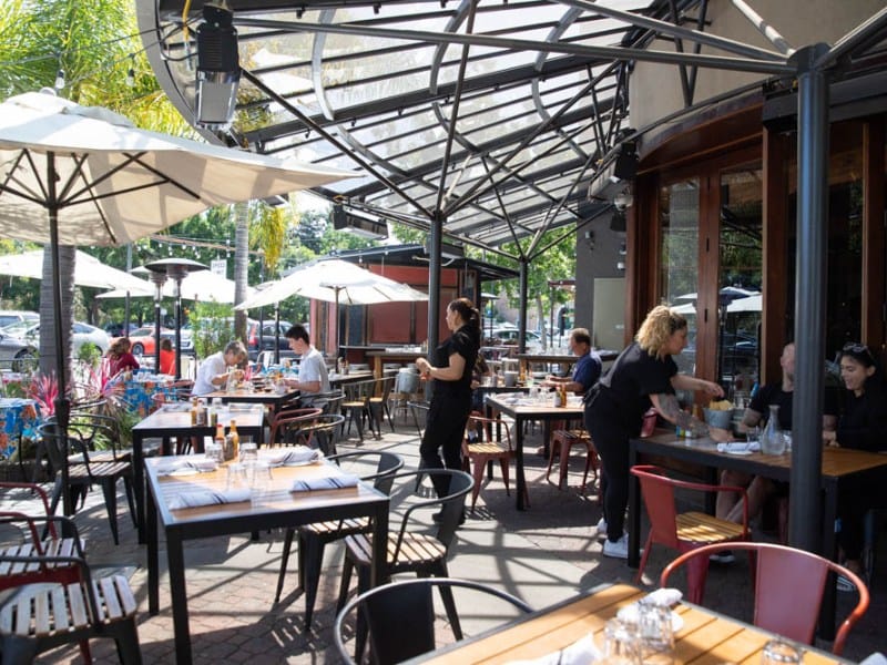 Vibrant outdoor dining at Milagros Latin Kitchen, perfect for casual events and meetings.