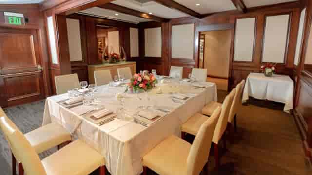Elegant Chef's Table setup with fine china for corporate retreats or private dinners.