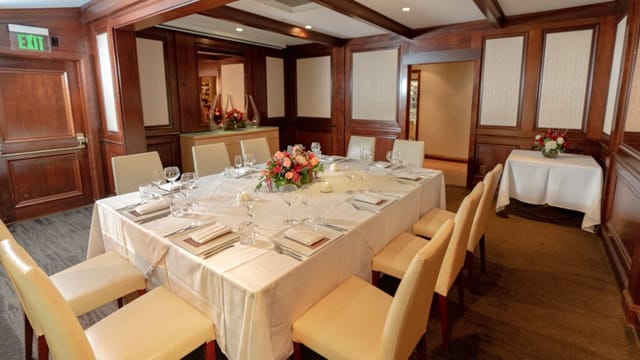 Elegant Chef's Table setup with fine china for corporate retreats or private dinners.