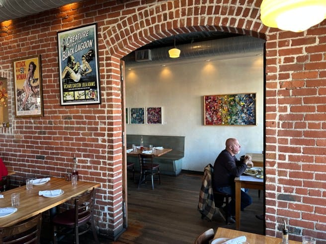 Cozy Diavola Dining Room with exposed brick, ideal for intimate gatherings and networking.