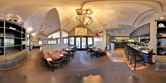 Stylish restaurant interior with warm lighting, perfect for corporate events and gatherings.