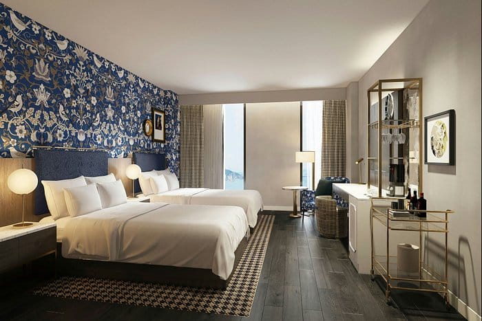 Elegant hotel room with two beds, ideal for business events and conferences.