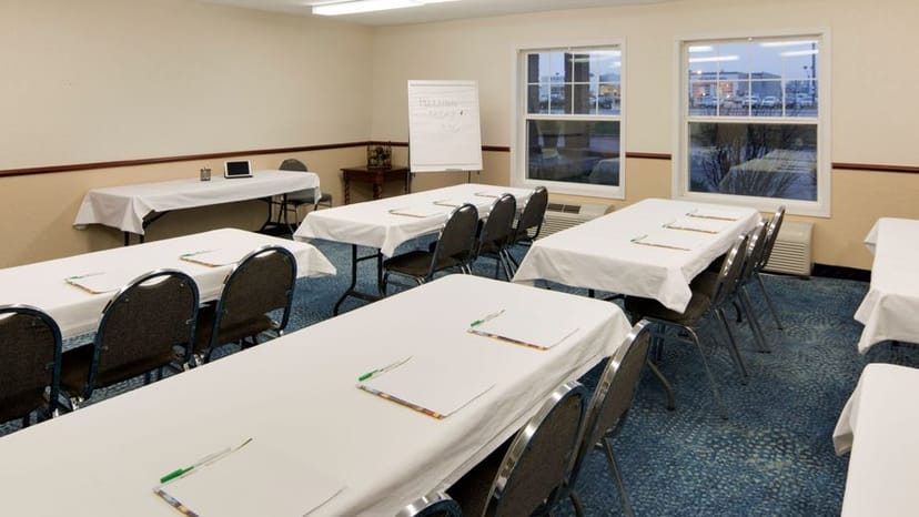 Conference Center room setup for presentations with classroom tables and natural light.