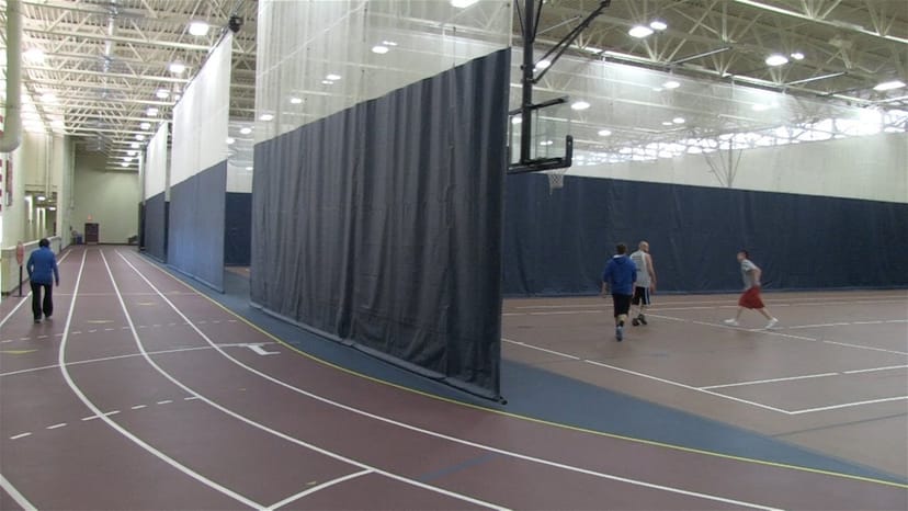 Gym at Redwood Area Community Center with divided courts for team-building events.