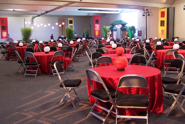 Cypress Hall banquet setup with red tablecloths, perfect for events and celebrations.