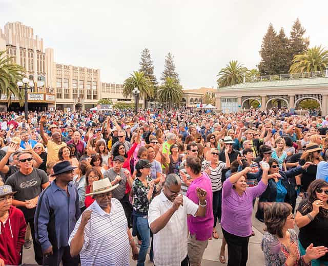 Vibrant crowd dancing at Redwood City event, showcasing engagement and social interaction.