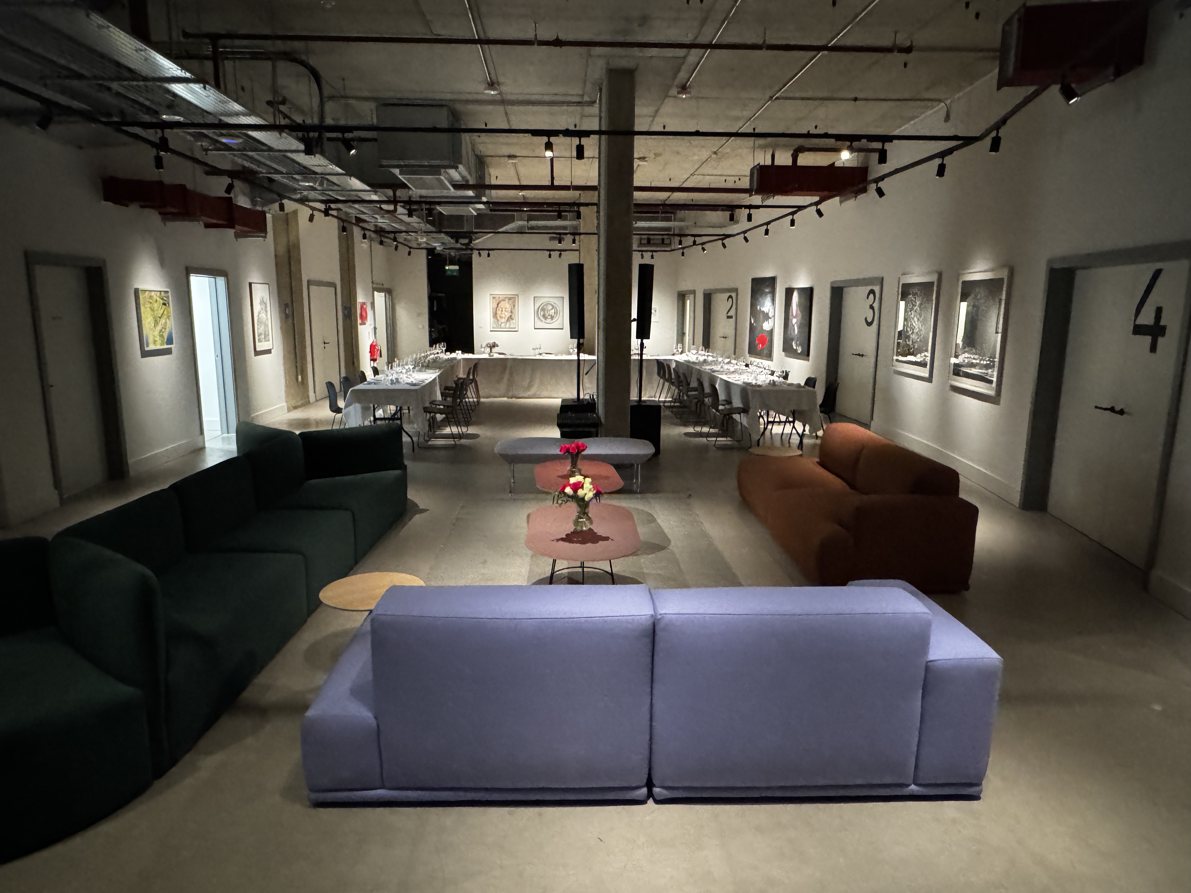 Versatile event space in The Art Academy with contemporary sofas for networking and gatherings. - Banner
