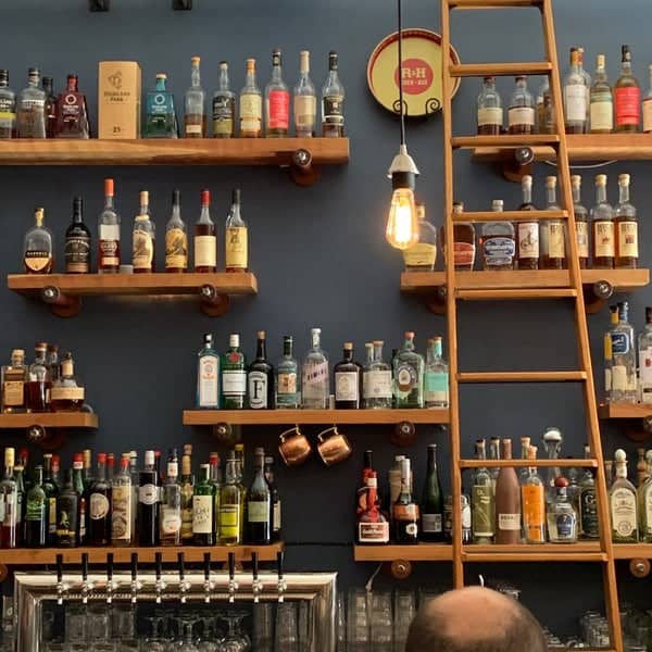 Inviting bar setup with liquor bottles at Martins West Gastropub, perfect for cocktail events.