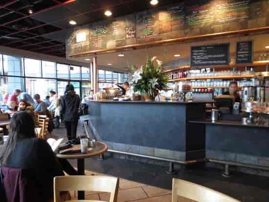 Vibrant Cafe Borrone with bright windows perfect for networking events and casual meetings.