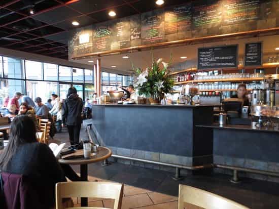 Vibrant Cafe Borrone with bright windows perfect for networking events and casual meetings.