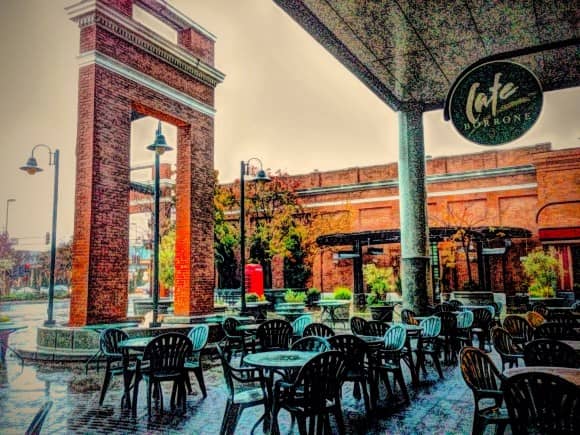 Outdoor Cafe Borrone with brick pillars, ideal for networking events and casual meetings.