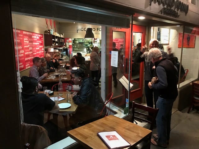 Lively Piccolo Forno restaurant, perfect for casual networking and small group dinners.