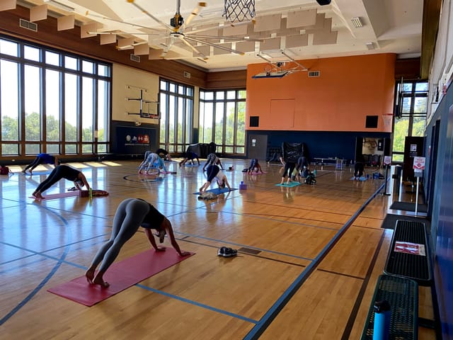 Spacious Bayview Room gym set for yoga class with natural light - wellness events, fitness workshops.