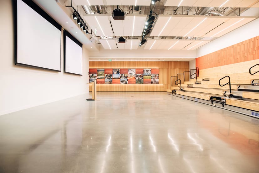 Event space with tiered seating and modern decor at Peninsula Community Center.