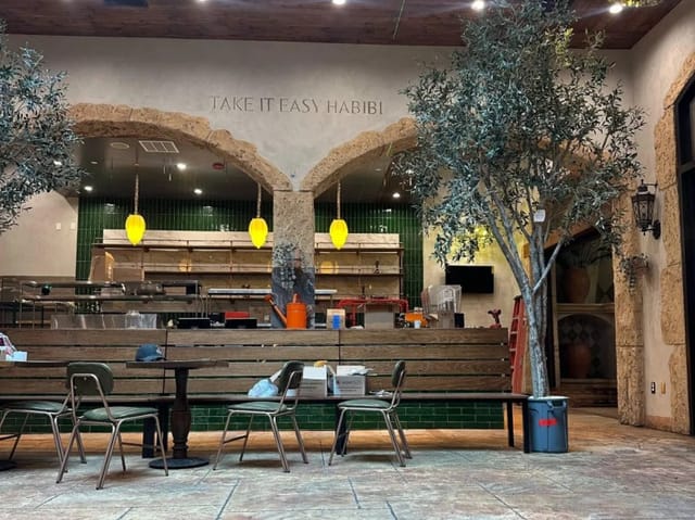 Cozy dining area in Mazra with olive trees, ideal for gatherings and events.