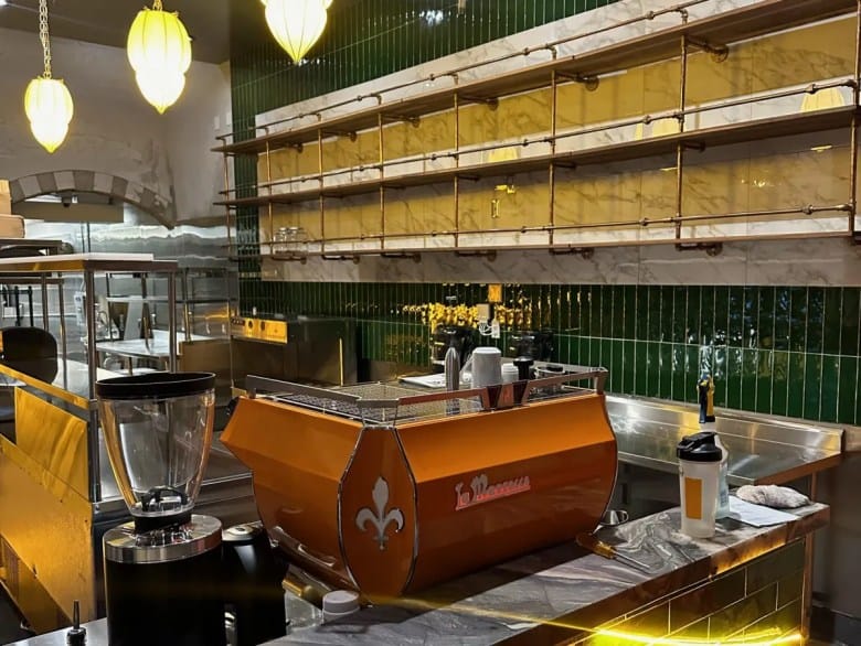Modern dining area in Mazra with orange coffee machine, perfect for upscale events.