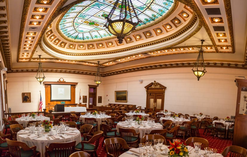 Elegant round tables in San Mateo County History Museum's grand courtroom event space.