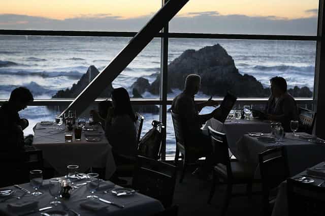 Main Dining Area at Cliff House, elegant tables, ocean view, ideal for corporate dinners.