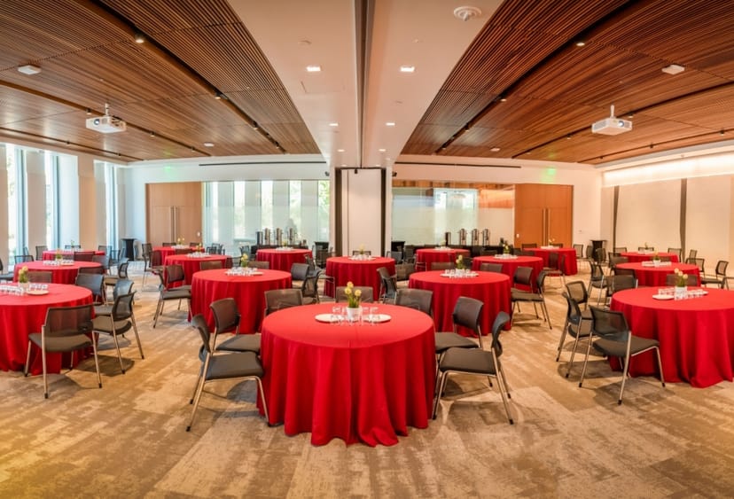 Conference room in Cordilleras Health Campus with red tables, perfect for meetings and banquets.