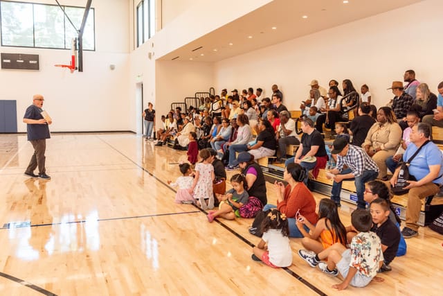 Onetta Harris Community Center event with diverse attendees in engaging gymnasium setting