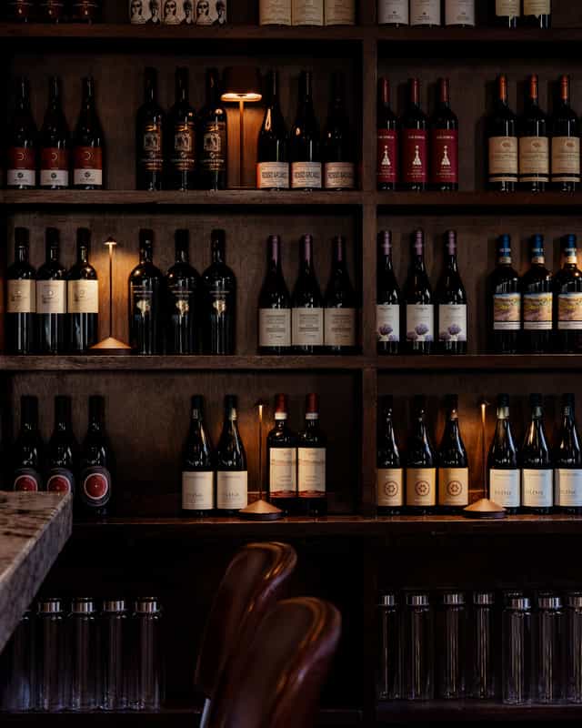 Elegant wine display at 54 Mint Cucina Romana for upscale events and networking.