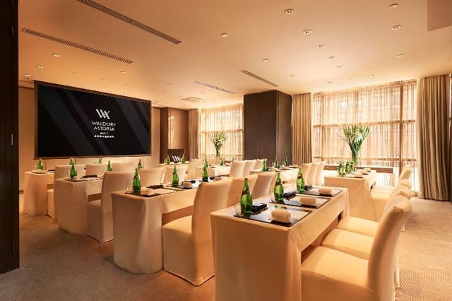 Waldorf Astoria Beijing meeting room with elegant tables for corporate events and workshops.