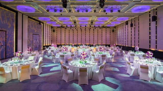 Elegant wedding venue in Sofitel Beijing with floral centerpieces and sophisticated lighting.