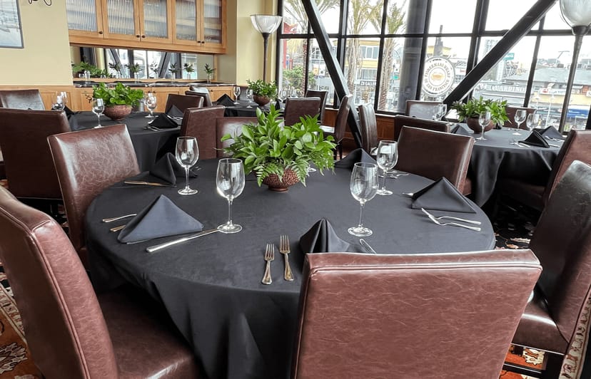Elegant Bistro Boudin lounge setup with dark linens for gatherings and events.