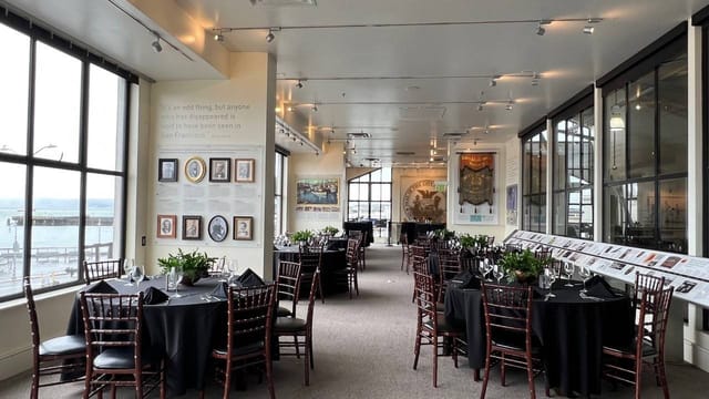 Elegant Bistro Boudin lounge with floral centerpieces, perfect for corporate events.