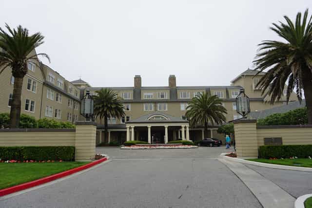 Ritz-Carlton Half Moon Bay entrance, elegant palm trees for upscale events and gatherings.
