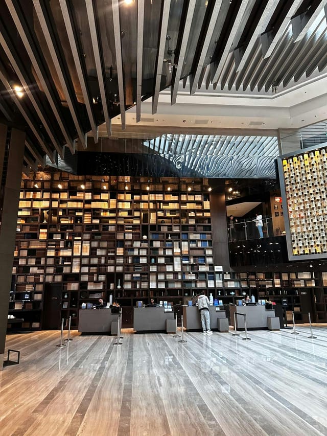 Modern event space with towering bookshelf for meetings at Renaissance Beijing Wangfujing Hotel.