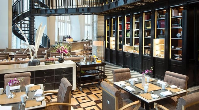 Elegant dining space with spiral staircase for corporate events in Conrad Beijing.
