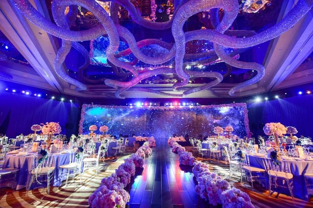 "Kunlun Ballroom in Beijing with intricate ceiling decor, ideal for luxury weddings and galas."