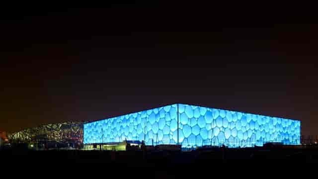 National Aquatics Centre with honeycomb exterior, ideal for modern evening events.