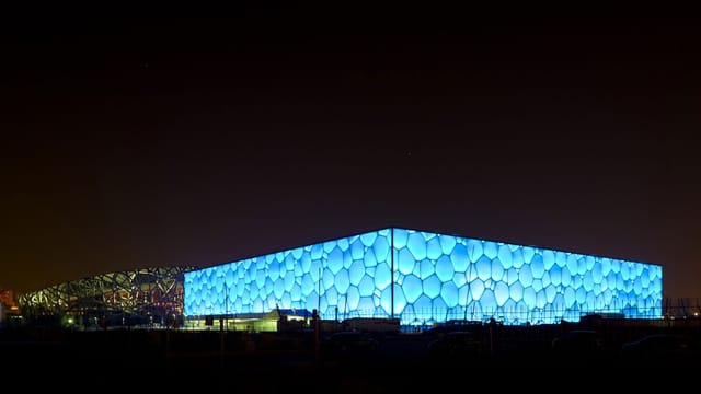 National Aquatics Centre with honeycomb exterior, ideal for modern evening events.