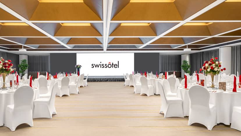 "Conference room at Swissôtel Beijing with elegant round tables, ideal for corporate events."