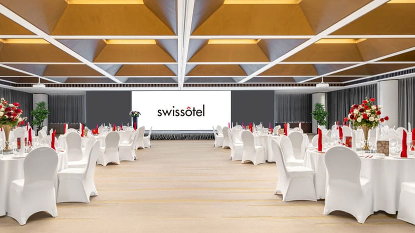 "Conference room at Swissôtel Beijing with elegant round tables, ideal for corporate events."