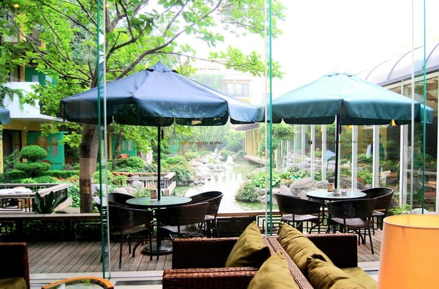Jianguo Hotel Beijing outdoor event space with elegant tables and serene garden views