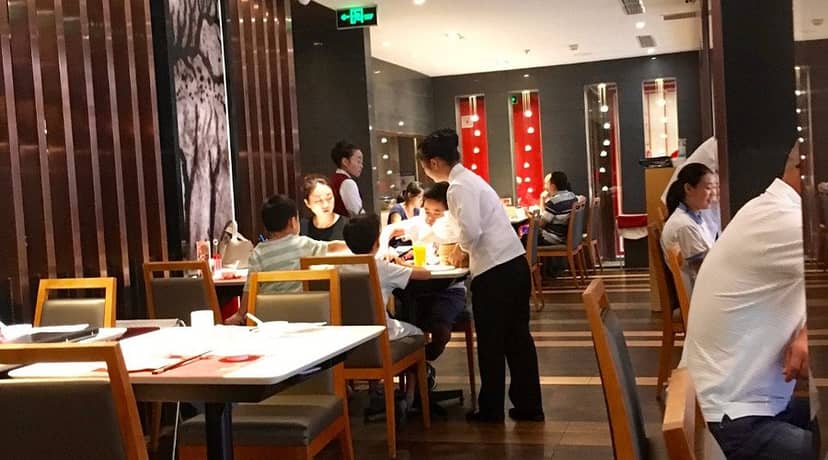 Lively Yuyang Hotel Beijing restaurant for informal meetings, featuring modern decor.