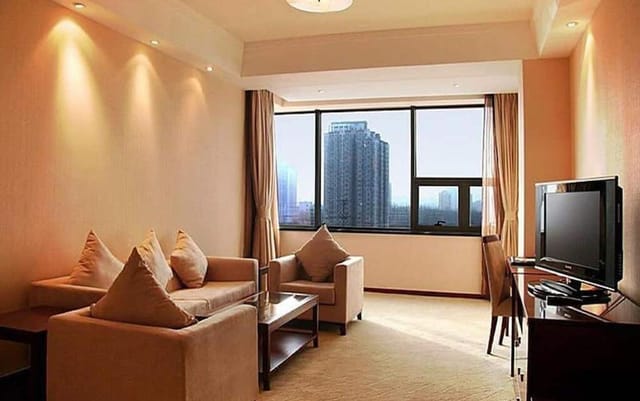 Beijing Jingyi Hotel meeting suite with cozy seating for workshops and client gatherings.