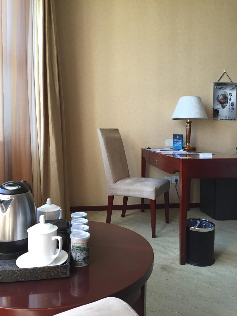 "Beijing Jingyi Hotel meeting space with elegant chair, ideal for productive discussions."